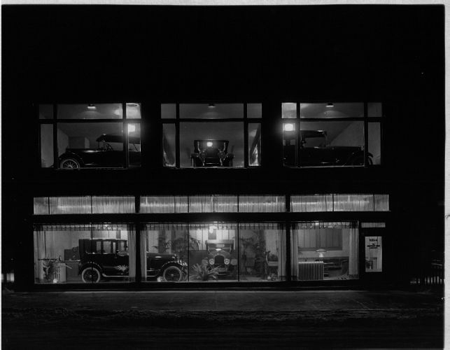 1918 night photograph of the two-story Sturtevant and Jones Automobile Dealership